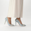 Side view of 'Celina Blue' A blue bridal court shoe with crystal embellishments, shown on a model - Freya Rose London