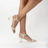 Martina Midi Champagne worn by a model - A shimmer suede mid-heel bridal shoe with Pearl Heels