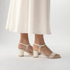 Martina Midi Champagne worn by a model - A shimmer suede mid-heel bridal shoe with Pearl Heels