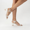 Martina Midi Ivory worn by a model - A shimmer suede mid-heel bridal shoe with Pearl Heels