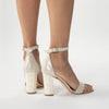 Freya Rose London 'Martene' Bridal Shoe shown on a model. Champagne suede sandal with block Mother of Pearl heel