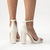 Model showing the back of 'Dove' by Freya Rose London - An ivory leather bridal shoe with pearl heel