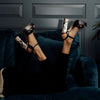 Model wearing 'Cher Noir' Couture designer womens shoes with pearl heel by Freya Rose London