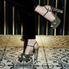 Model wearing 'Cher Verde' Couture designer green womens shoes with pearl heel by Freya Rose London