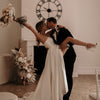 Newlywed couple embracing bride is wearing Freya Rose Satin Bridal Shoes