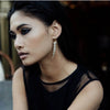 Delicate Gold pearl Drop Earrings shown on a model by Freya Rose London