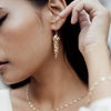 The Oval Crystal Framed Necklace and Gold Midi Crystal Drops worn by a model by Freya Rose London