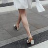 The back view of Martina Midi Ivory worn by a model - A shimmer suede mid-heel bridal shoe with Pearl Heels