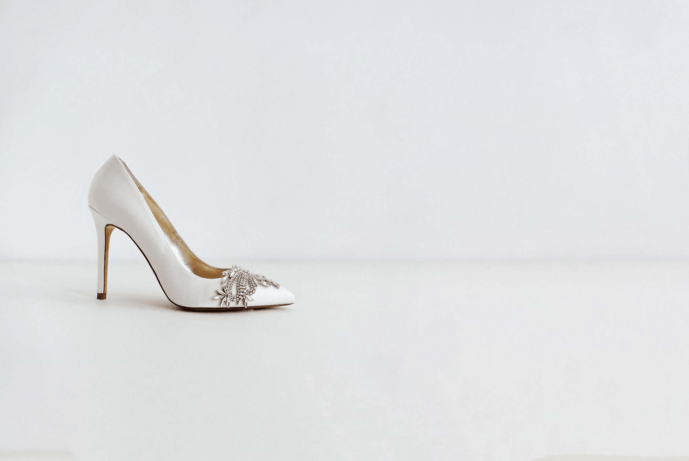 A Freya Rose Ivory Wedding Shoe on a white background.