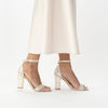 Freya Rose London 'Martene' Bridal Shoe shown on a model. Champagne suede sandal with block Mother of Pearl heel