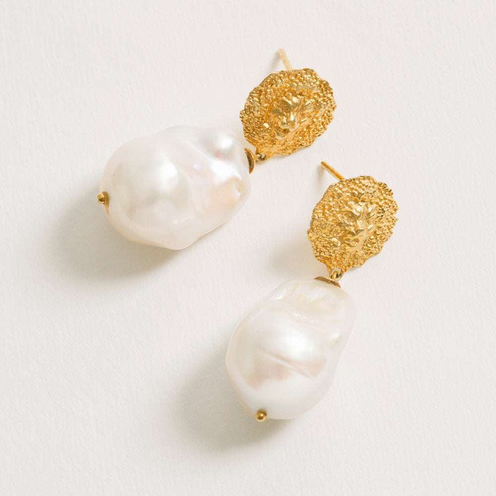 Lion pearl drop earrings in 18ct gold vermeil featuring textured lion motif and baroque pearl drops.